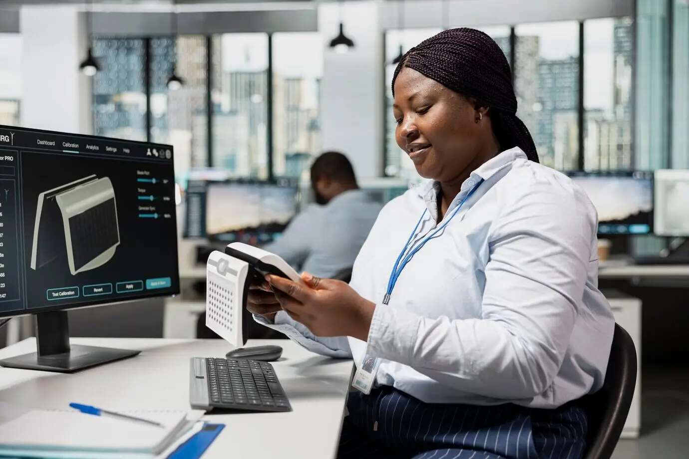 Cheerful CAD product designer in an office designing a solar device for sustainable energy.