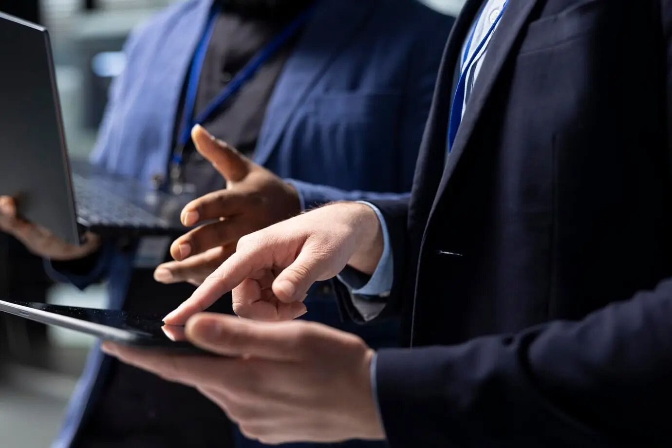 Technicians and building contractors from diverse ethnic backgrounds analyzing data